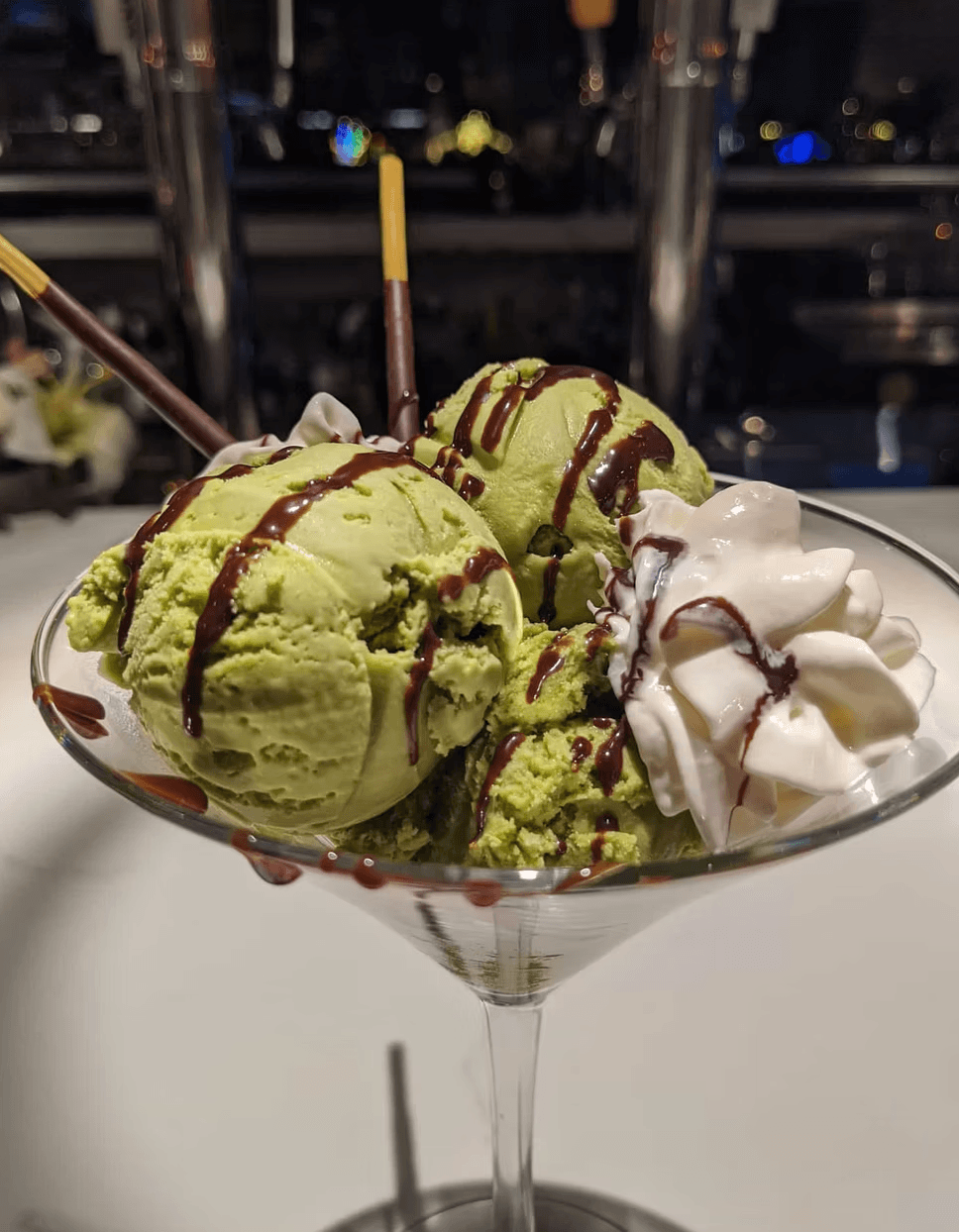 Matcha ice cream sundae with Pocky and chocolate drizzle